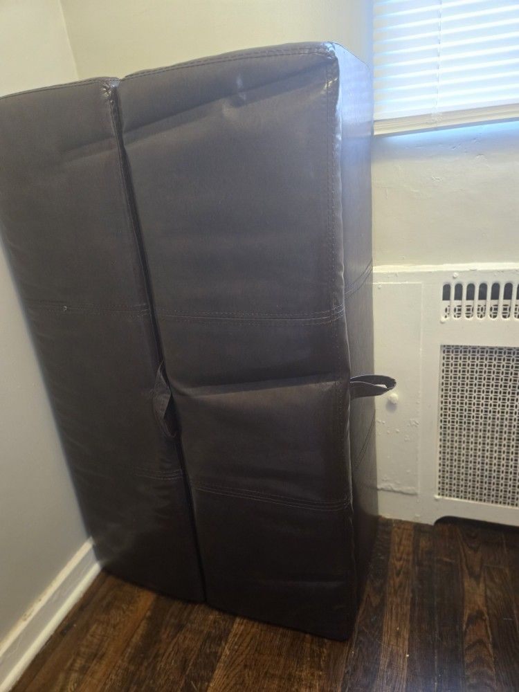 Brown Ottaman Table That Pulls Out Into A Bed