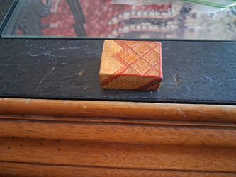 box features intricate geometric straw marquetry or woven bamboo pattern