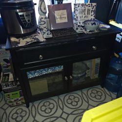 Black cabinet for dining area to put things on and storage underneath glass doors