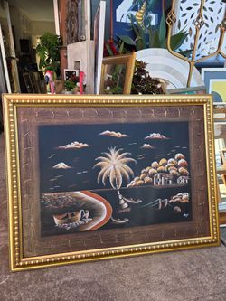 A vintage-style painting shows a tropical landscape with a palm tree and a boat on the beach.