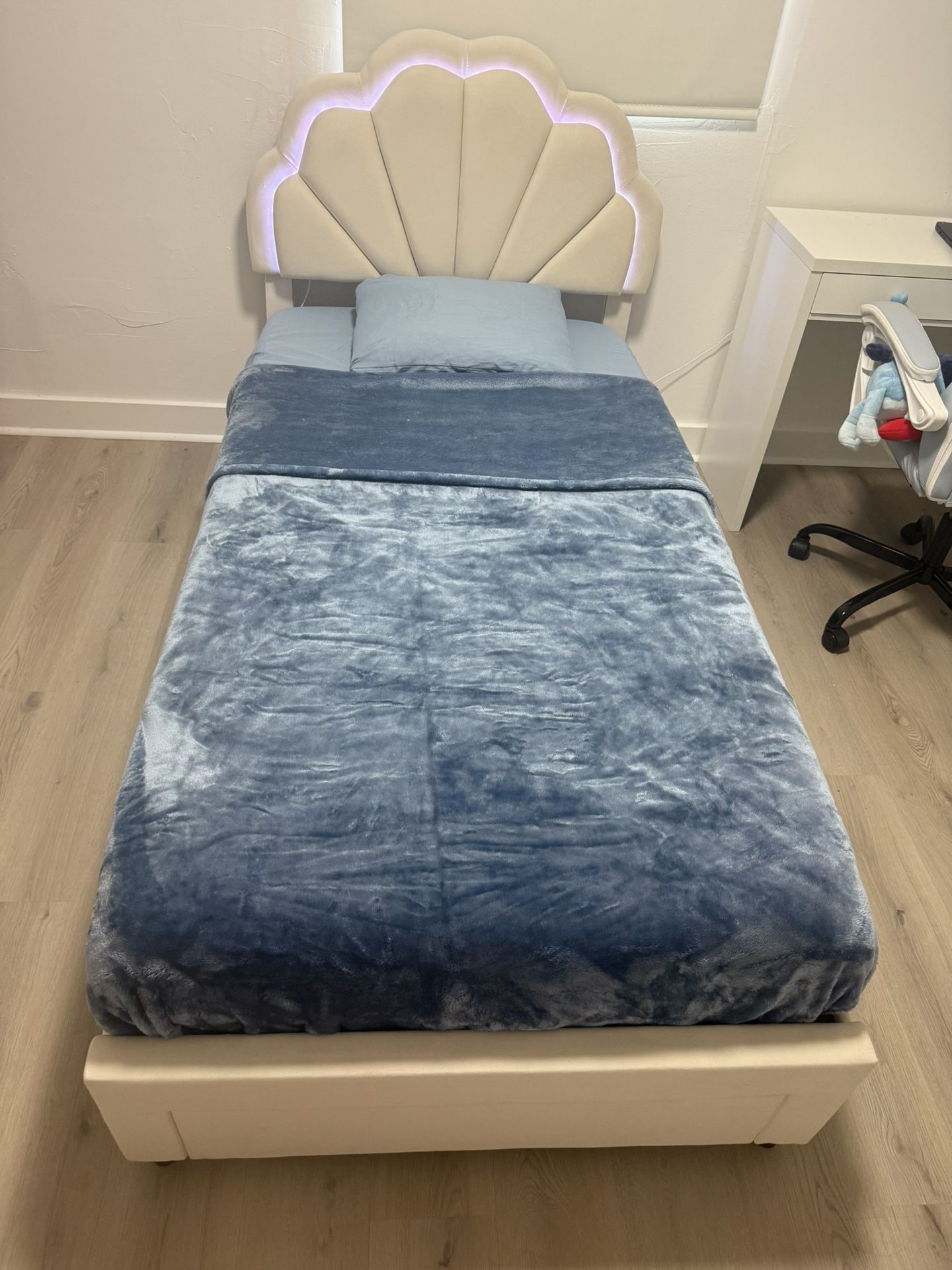 Beige Twin size bed with LED lights and storage drawer, no mattress.