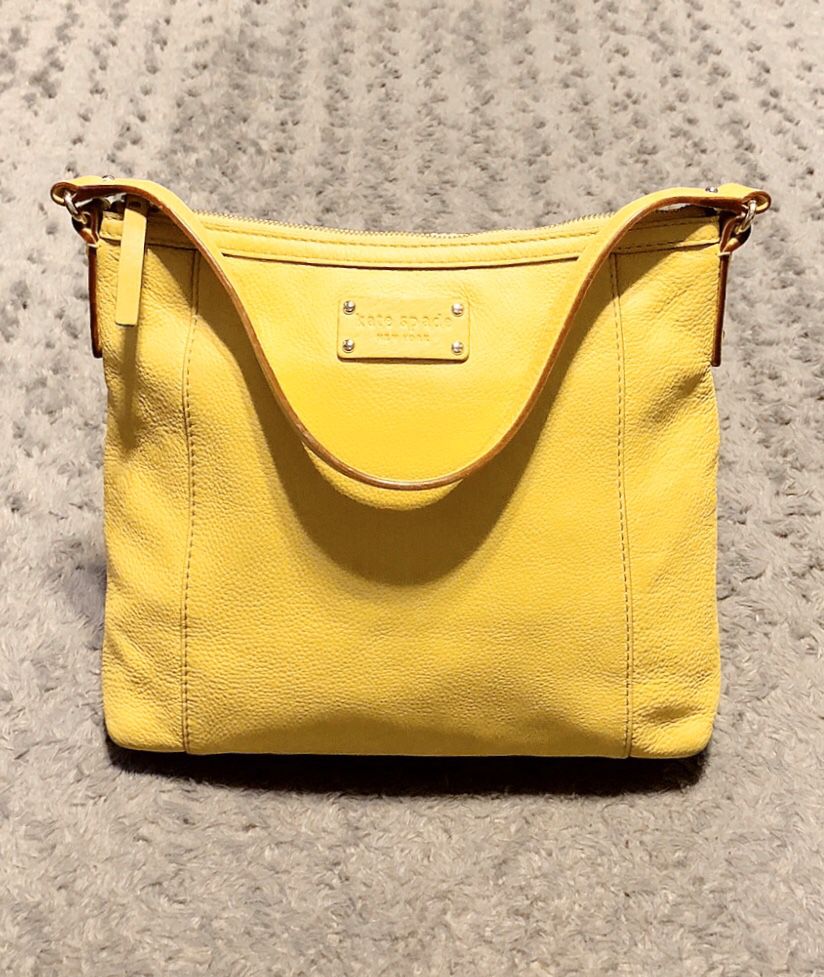Kate Spade pebble leather shoulder bag paid $285 Color Yellow. Measurements approx 11in L, 2in W, 10.5 H. Has a blemish on back of bag & minor pen ma