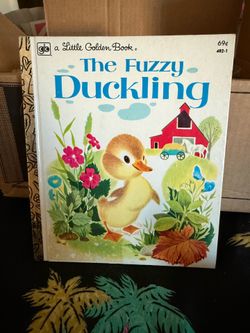 Vintage duck figurine and books