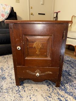This is a vintage wooden nightstand or end table with a drawer and a cabinet.