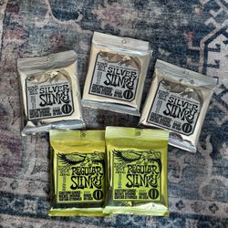 Ernie Ball Guitar Strings Bundle: 2 Regular Slinky + 3 John Mayer Silver Slinky Signature Packs – Brand New & Sealed! – $40