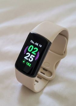 Fitbit charge 5  with lunar white band tracks sleep, heart rate exercise and fitness smartwatch tracker