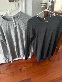 Lululemon Swiftly Tech top (likely a long-sleeve tee) in a heathered grey or slate and black.