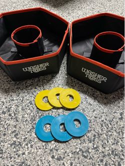 The Folding Washer Toss Washers Game Set includes 2 targets and yellow/blue washers, providing all the necessary components for a fun outdoor game. Th