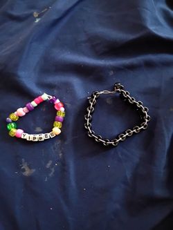 A colorful random bracelet and a black cuff bracelet