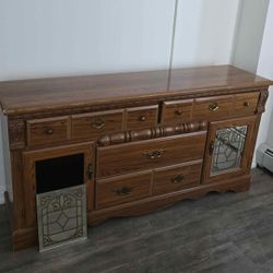 Brown wooden dresser lights up mirror