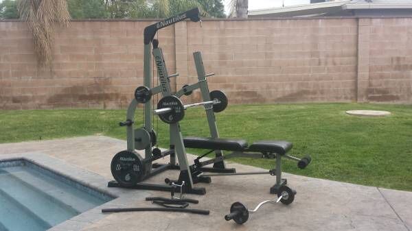 Nautilus squat rack w/Hi & low pulley system, weights & bench included
