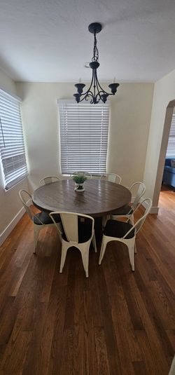 Beautiful round solid wood dining table with 7 matching metal chairs