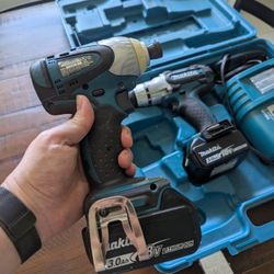 Makita hammer drill and impact driver set with 2 18v batteries, charger, and carrying case