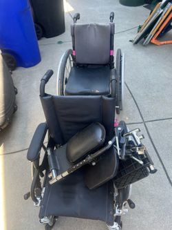 Two youth wheelchairs both stand 30 inches high at the back