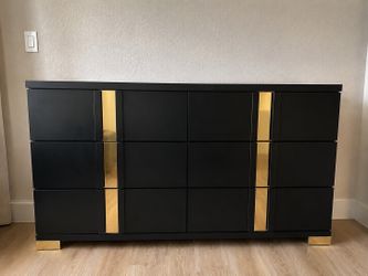 Beautiful black and gold dresser in excellent condition. Modern glam design with sleek black finish and gold accent details. Features ample storage