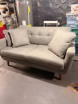Grey modern sofa with minor wear