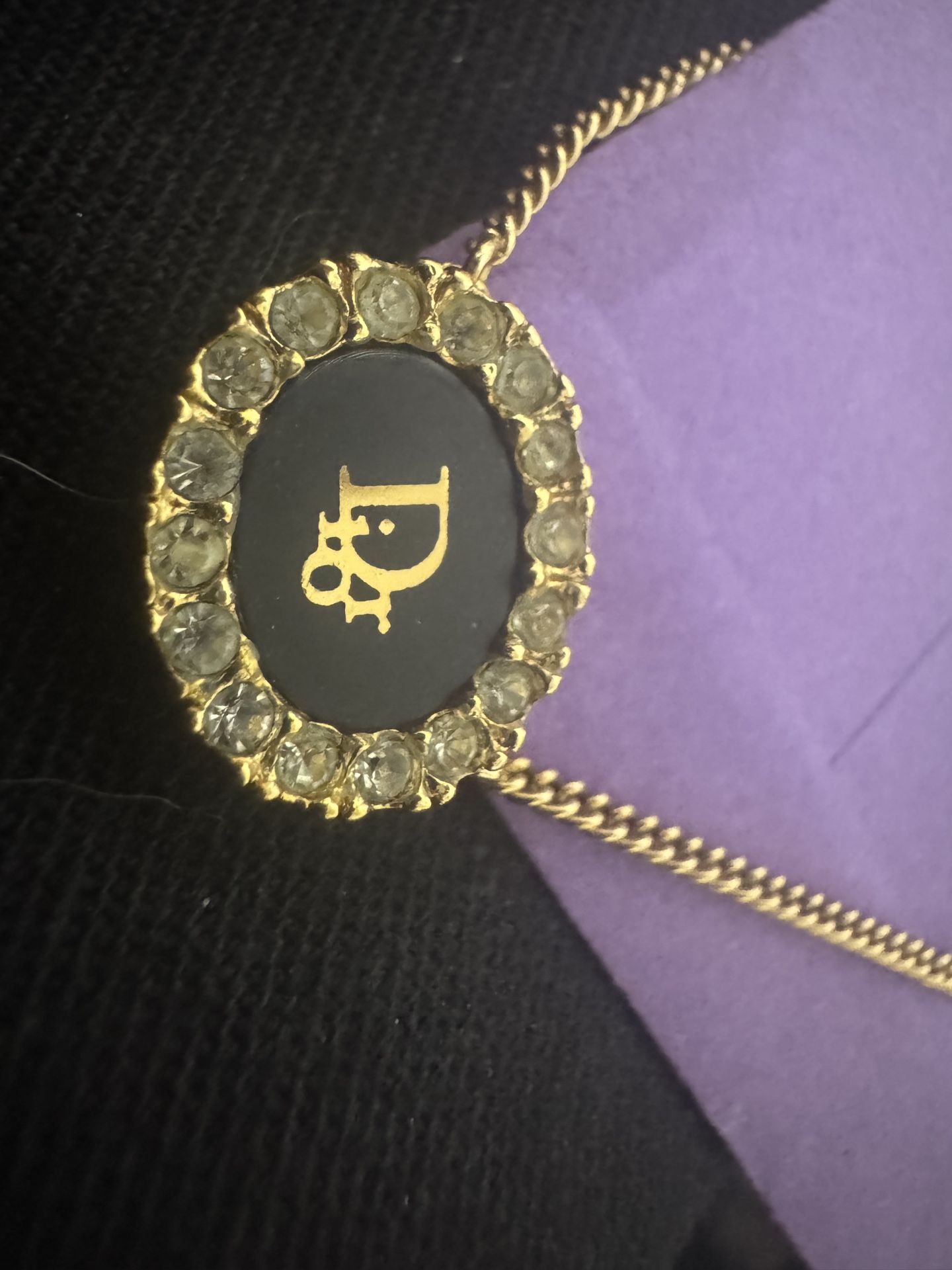 This is a gold "circle of life" pendant necklace.