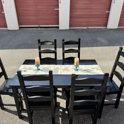 Black wooden table and six chairs