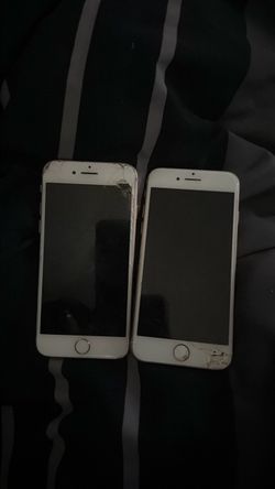 Two Apple iPhones with Cracked Screens