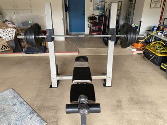 Gold gym weight bench. Olympic size bar and weights.