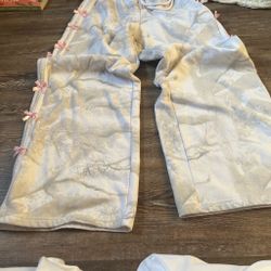 Gray and white sweats with white stripes on the side with bows
