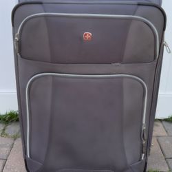 Selling large gray checked suitcase.