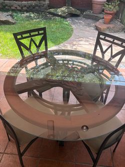 Glass and iron table with chairs