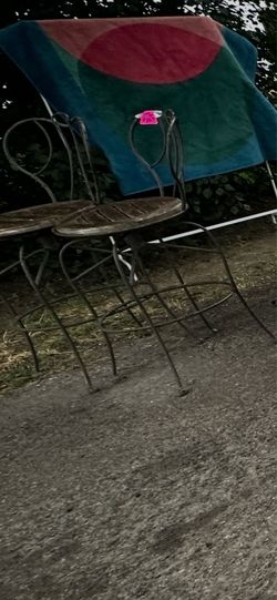 two tall iron metal chairs