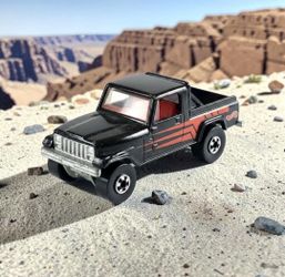 1997 Hot Wheels Blck Off-Road Jeep Scrambler Trailbuster Die-Cast 1:64 Truck Toy. This is a 1997 Hot Wheels Trailbuster (often identified as a Jeep Sc