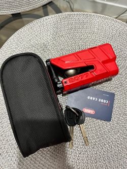 ABUS GRANIT Detecto XPlus 8077 is a heavy-duty, high-security motorcycle and scooter brake disc lock featuring an integrated electronic alarm system.