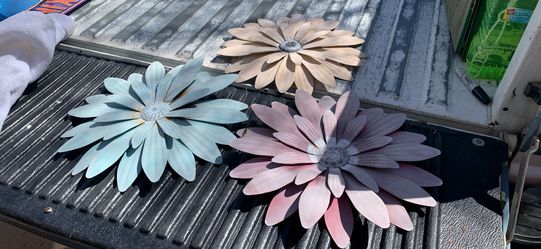 Three  yard art metal flowers in good condition. These measure 16 inches wide 16 inches tall.