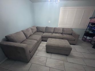 Light Grey Sectional with blanket storage ottoman