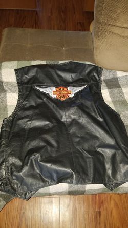 Size large leather vest with a couple of Harley patches