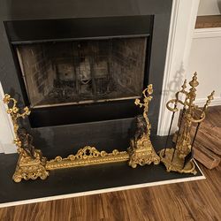 Cupid fireplace, fender, and irons