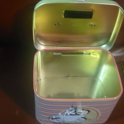 Betty Boop collectible tin container or lunch box. It features a colorful striped design around the body and a graphic of Betty Boop and other charact