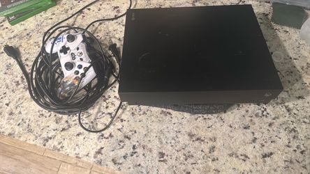 Black Xbox One X (and power cord), (wired) controller, HDMI cord