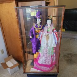 Dolls in a glass box.