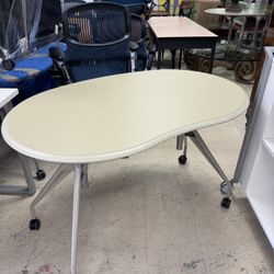 HERMAN MILLER kidney-shaped tabletop supported by three adjustable legs with casters - 47” x 30” - Excellent Condition- Originally $1899