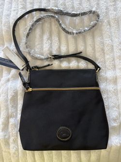 New with tags dooney and Bourke crossbody bag with zipper pockets and red interior
