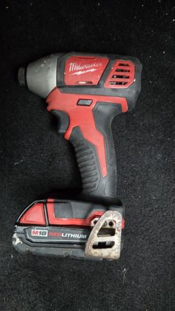 Milwaukee M18 1/4 inch hex impact driver and an M18 REDLITHIUM battery