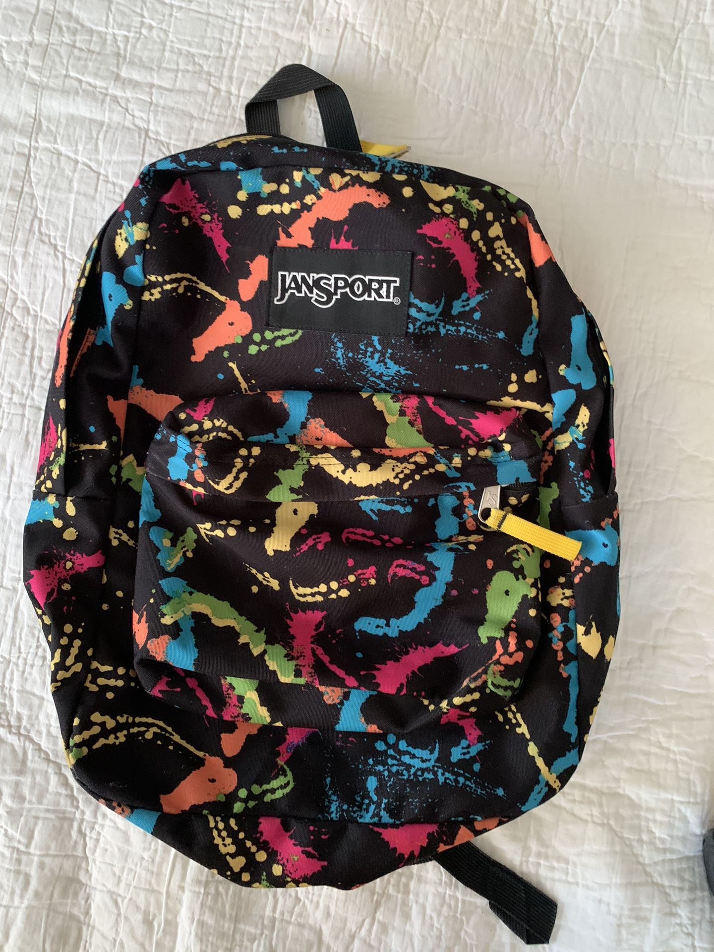 Jansport Superbreak One Backpack School Travel or Work, black with fun bright paint splotch pattern