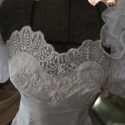 Four wedding gowns with accessories