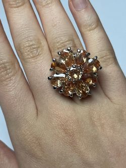 Silver and rhodium rings with honey-colored cubic zirconia stones; beautiful design.