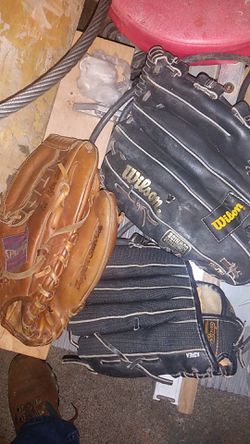 3 r handed gloves. 2 are Wilson