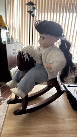 Collectible doll on rocking horse
