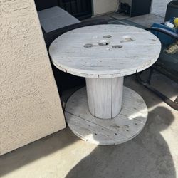 White Washed Spool Table. 24 Inches Tall By 26 Inches Diameter.