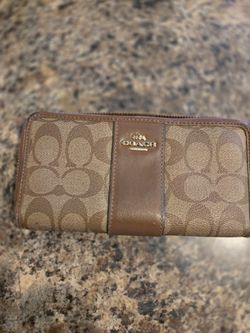 Coach brown wallet with zipper and some peeling on the inside