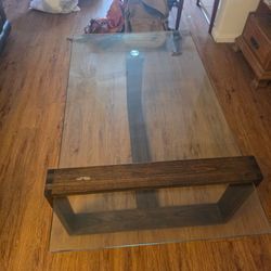 Floating glass table with dark wood frame