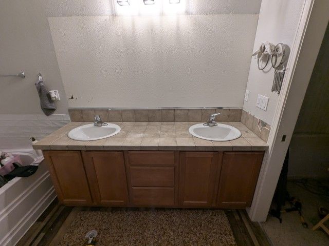 79.25" Dual sink bath vanity cabinet with top, sinks, and faucets and box of tiles