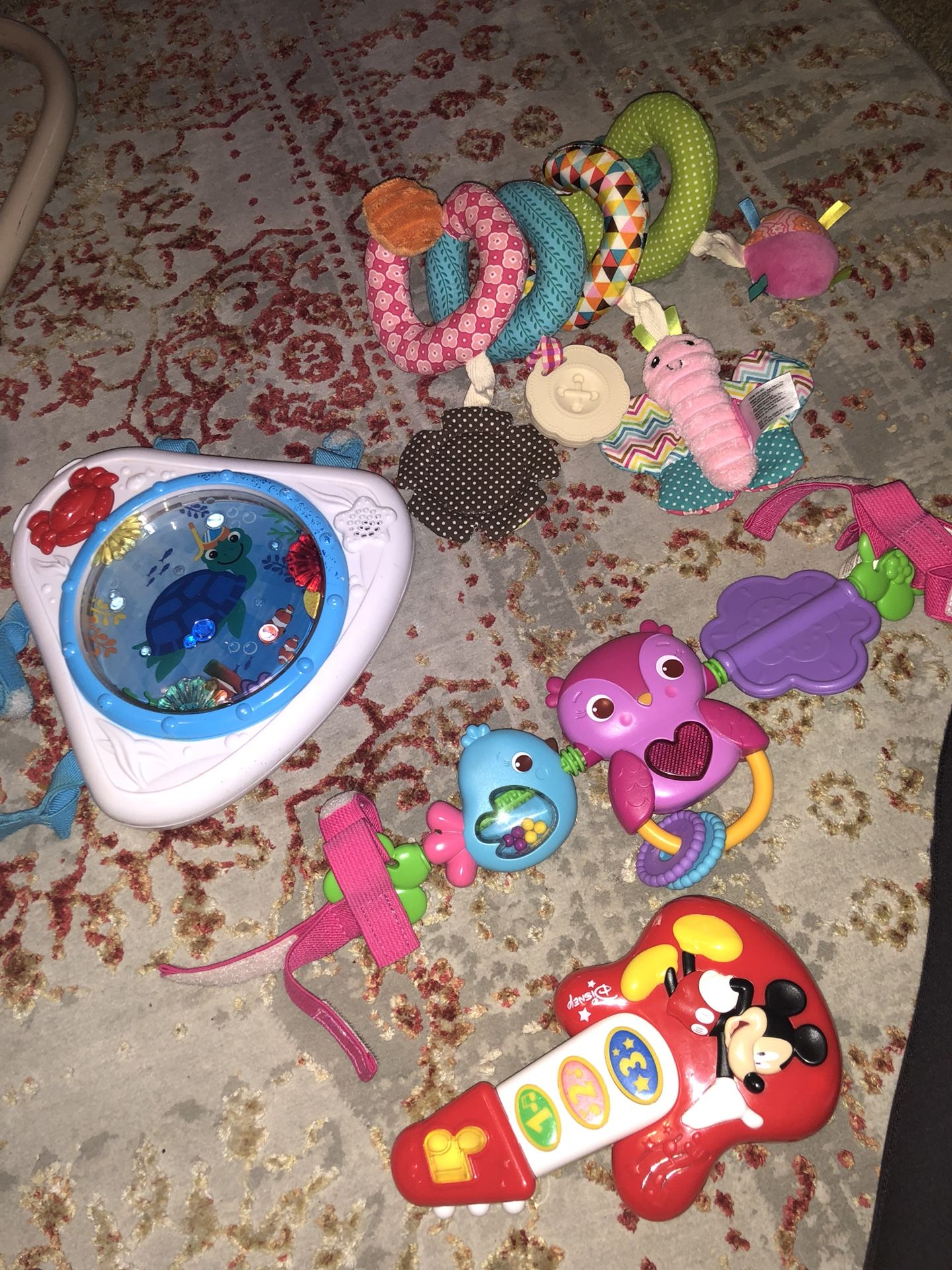 Baby toys including, toy guitar, car/ stroller toys and a baby Einstein music and light toy.